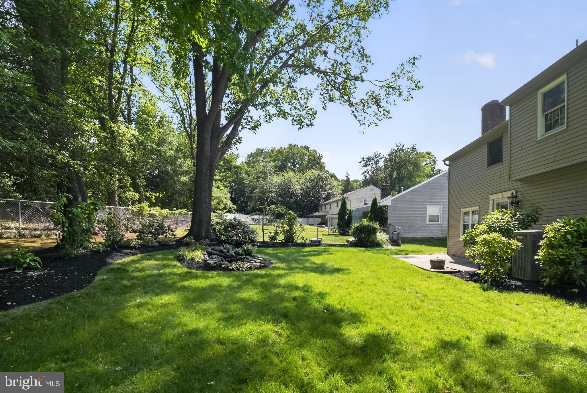 549 Covered Bridge Road Cherry Hill, NJ 08034 - Photo 9 of 16 a view of a backyard with table and chairs and potted plants and large trees