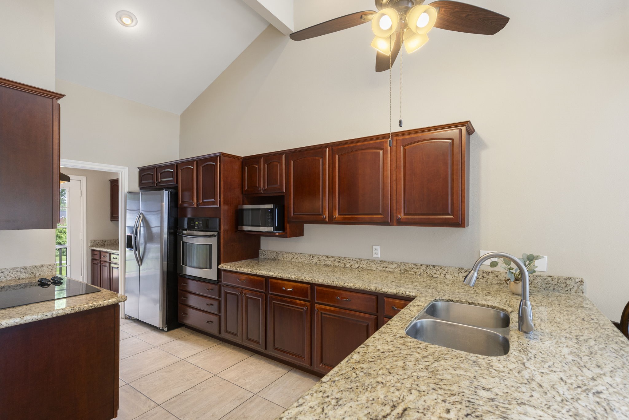 49 April Village Conroe, TX 77356 - Photo 11 of 46 a kitchen with stainless steel appliances granite countertop a sink refrigerator and cabinets