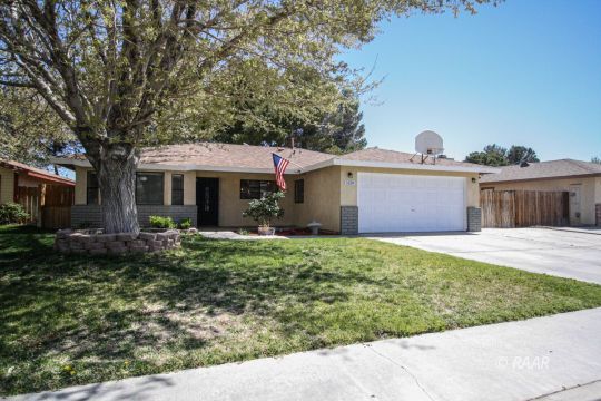 1124 Faith Court Ridgecrest, CA 93555 - Photo 1 of 35 a front view of a house with a garden