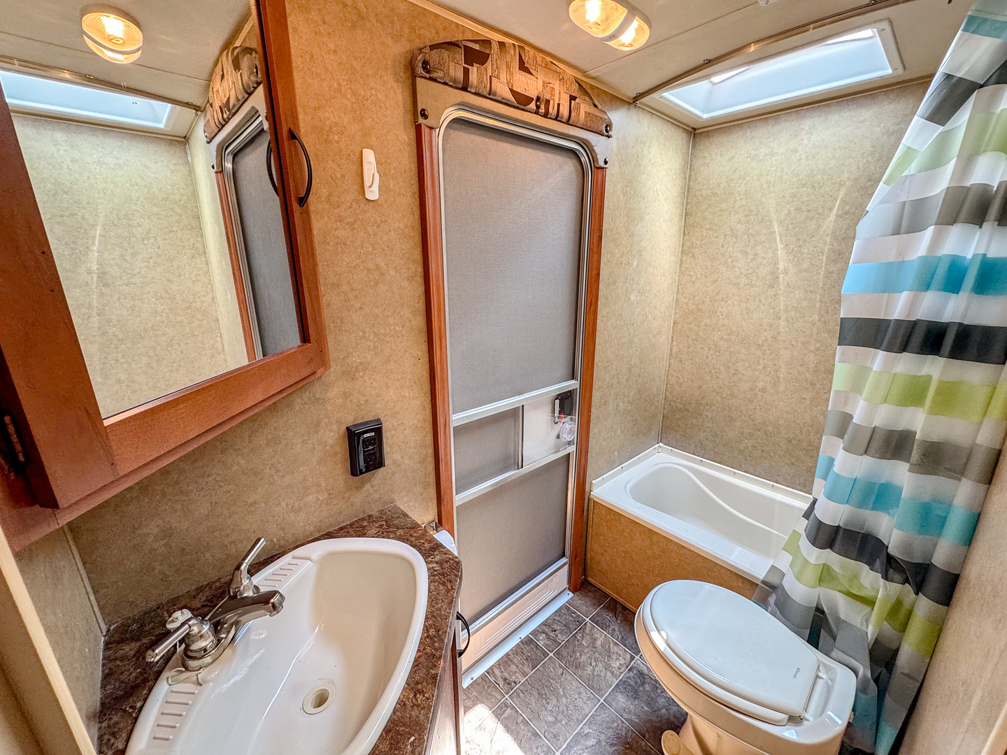 8-110 Woodhaven Sublette, IL 61367 - Photo 13 of 13 a bathroom with a sink a toilet a mirror and shower