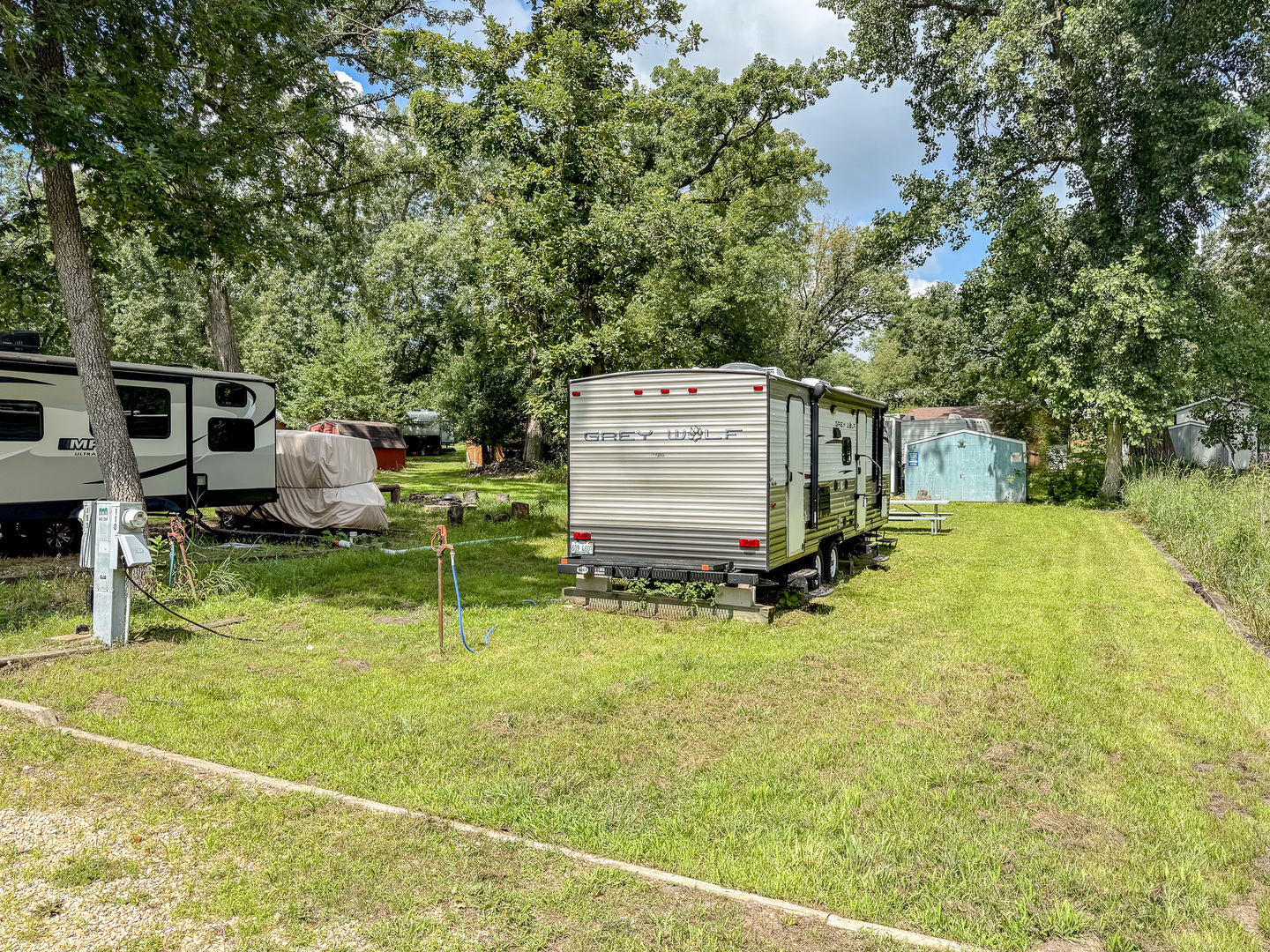 8-110 Woodhaven Sublette, IL 61367 - Photo 2 of 13 a backyard of a house with tub and trees