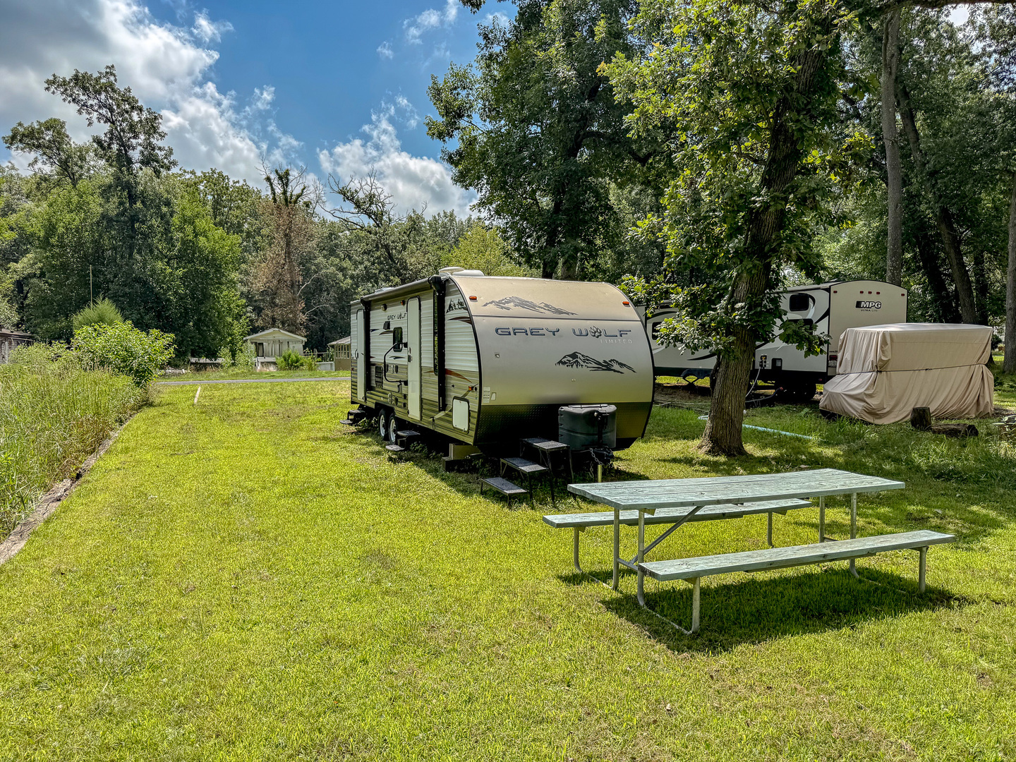 8-110 Woodhaven Sublette, IL 61367 - Photo 4 of 13 a swimming pool with some trees in the background