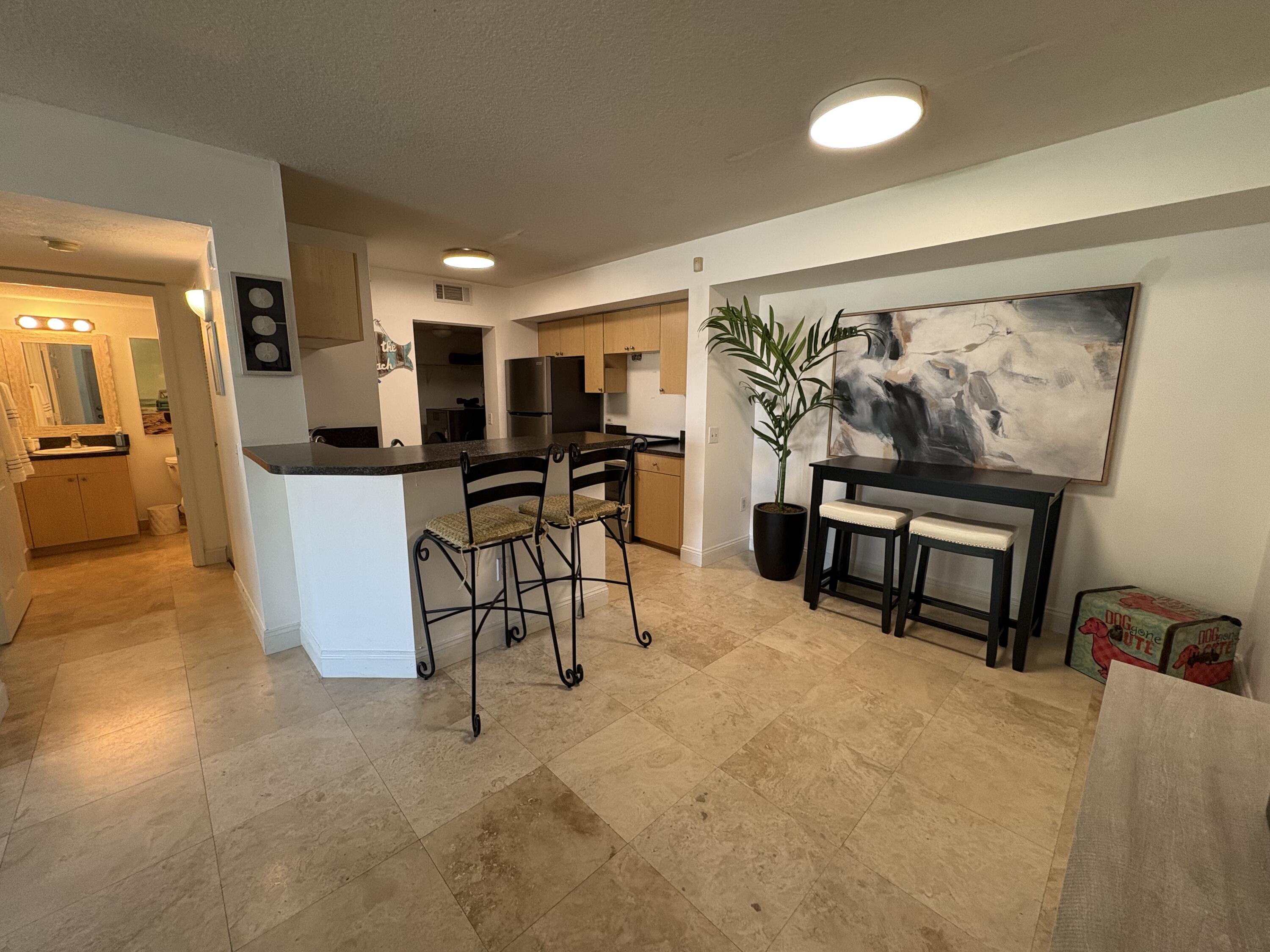 1205 Villa Lane, Unit 1205 Boynton Beach, FL 33435 - Photo 8 of 19 a living room with furniture and a flat screen tv