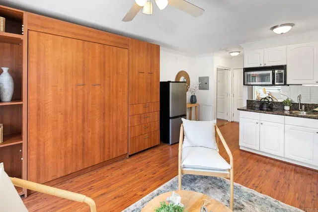 a kitchen with stainless steel appliances granite countertop a refrigerator and a stove top oven