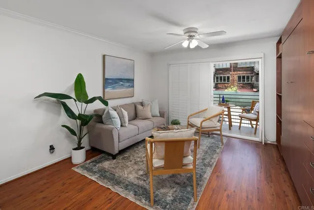a living room with furniture and a wooden floor