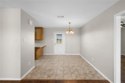a view of a livingroom with furniture nad kitchen view