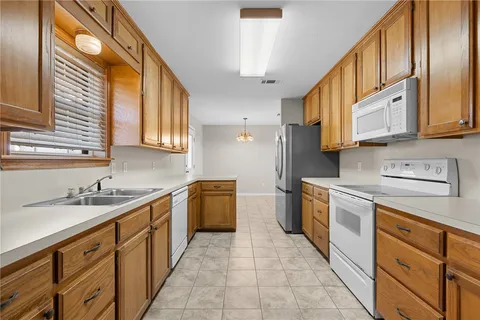 a utility room with a sink dryer and washer