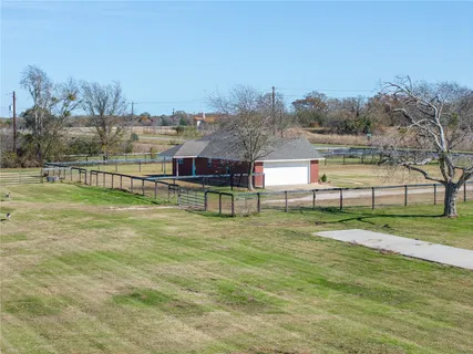 a view of residential houses with outdoor space and trees