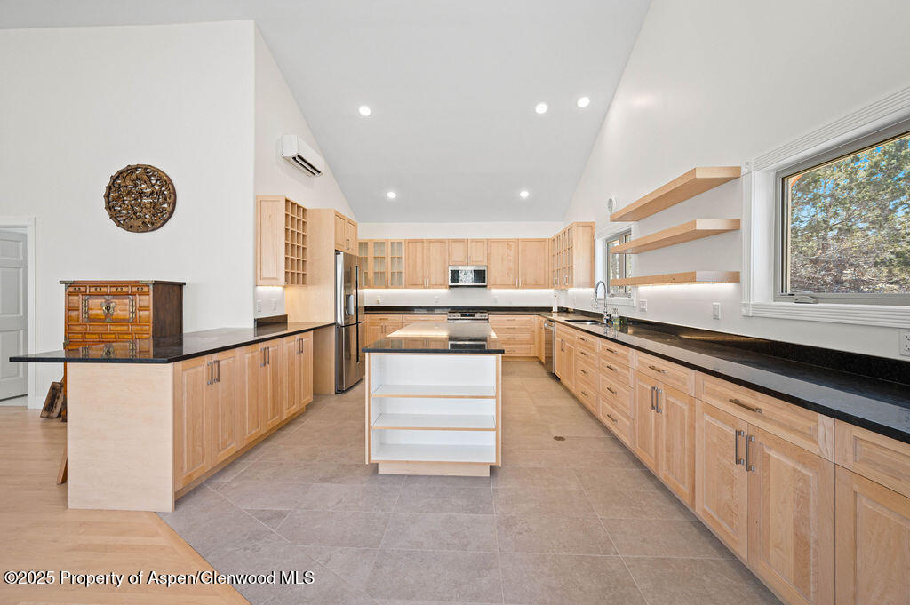 53404 Highway 330 Collbran, CO 81624 - Photo 19 of 43 a large kitchen with stainless steel appliances kitchen island granite countertop a large counter top and a stove top oven