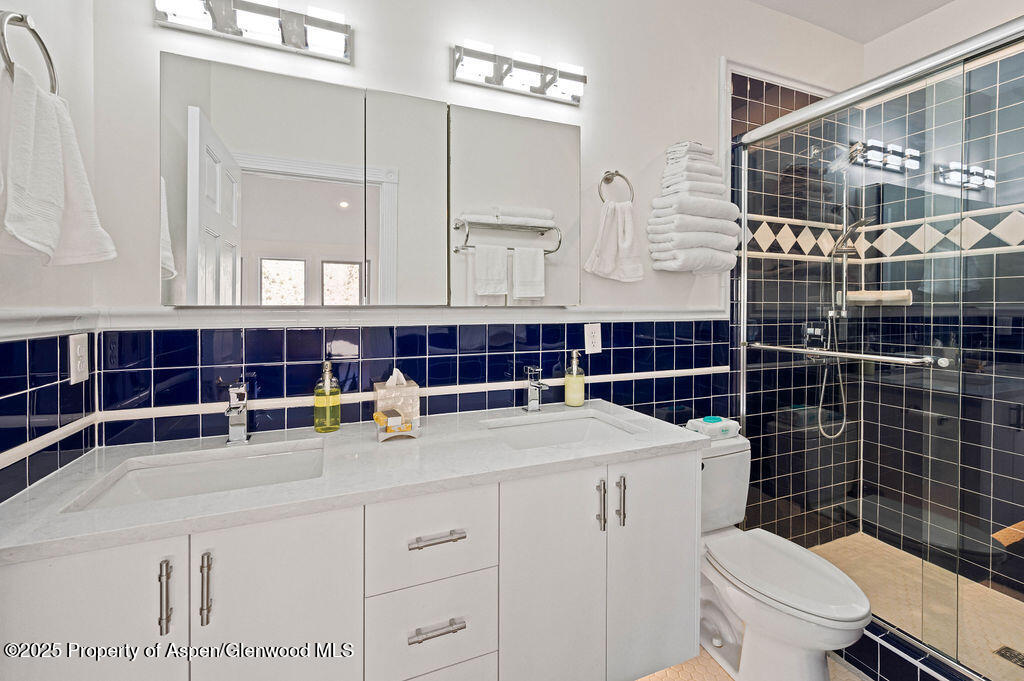 53404 Highway 330 Collbran, CO 81624 - Photo 23 of 43 a bathroom with a toilet a sink and shower