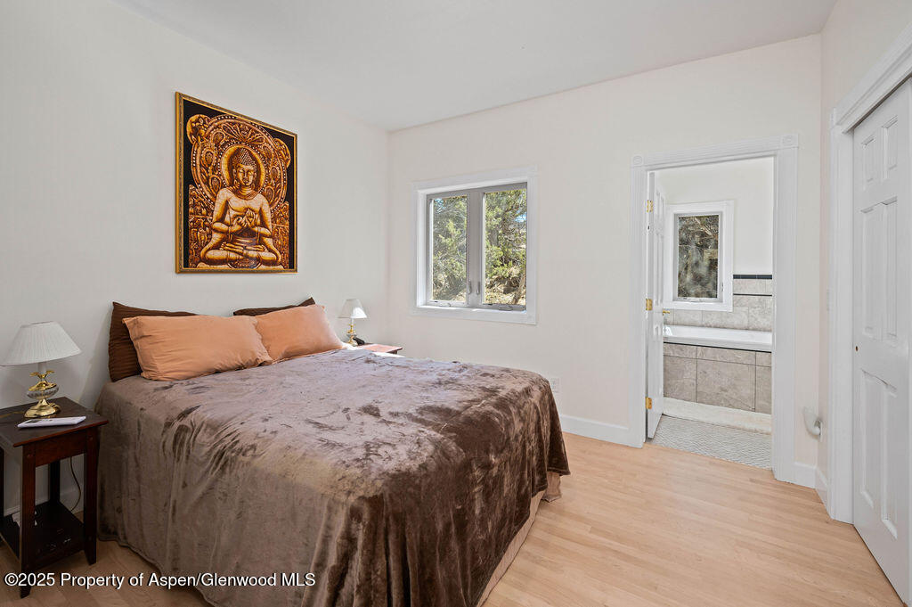 53404 Highway 330 Collbran, CO 81624 - Photo 24 of 43 a bedroom with a bed and a painting on the wall