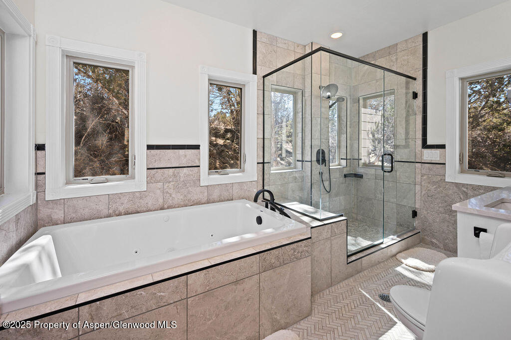 53404 Highway 330 Collbran, CO 81624 - Photo 26 of 43 a bathroom with a bathtub and a shower