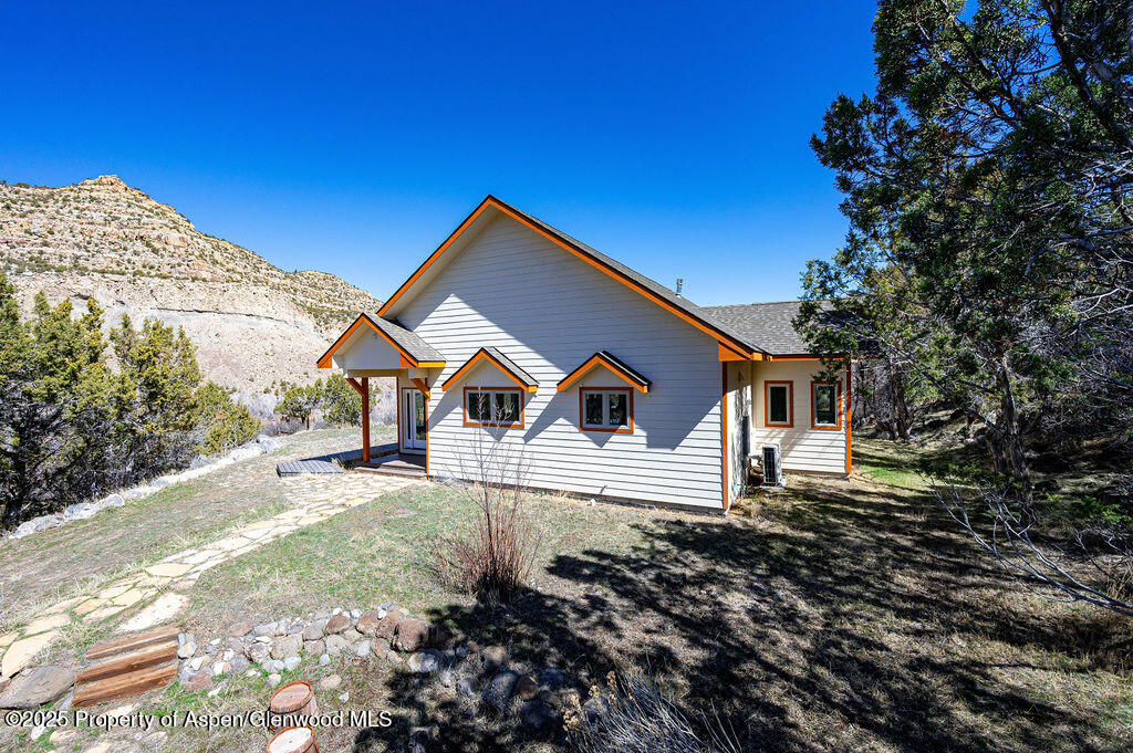 53404 Highway 330 Collbran, CO 81624 - Photo 4 of 43 a front view of a house with a yard