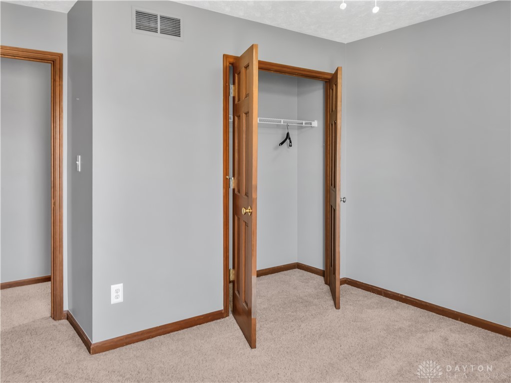 25 Callaway Springboro, OH 45066 - Photo 32 of 51 This spacious bedroom offers comfortable carpeting and a convenient closet, perfect for personalizing your private retreat.