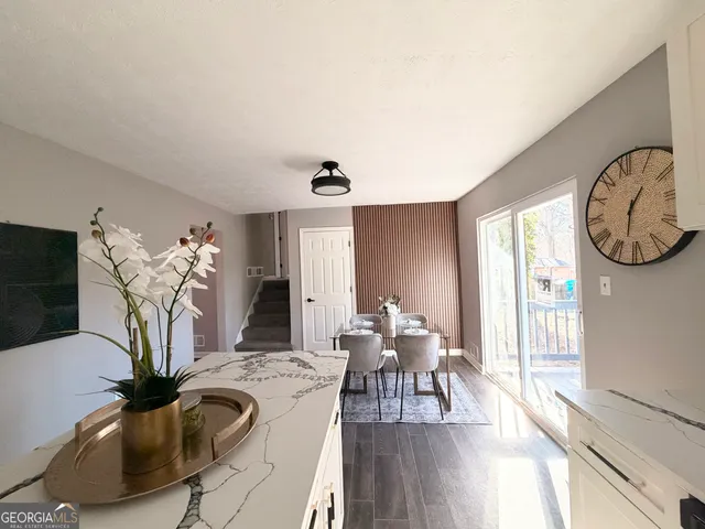 a living room with furniture a chandelier and a flat screen tv