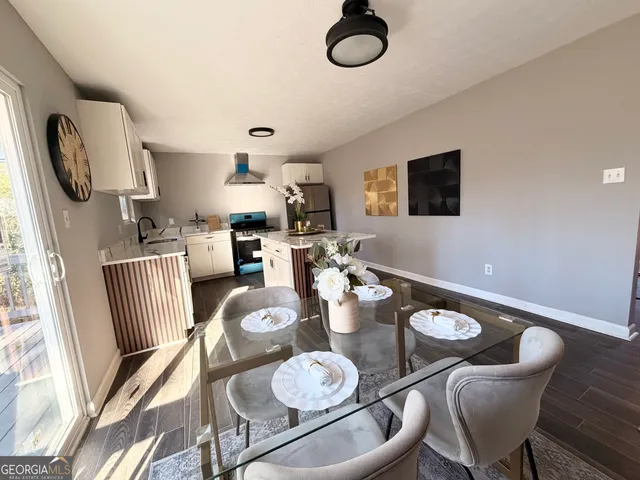 a living room with furniture chandelier and kitchen view
