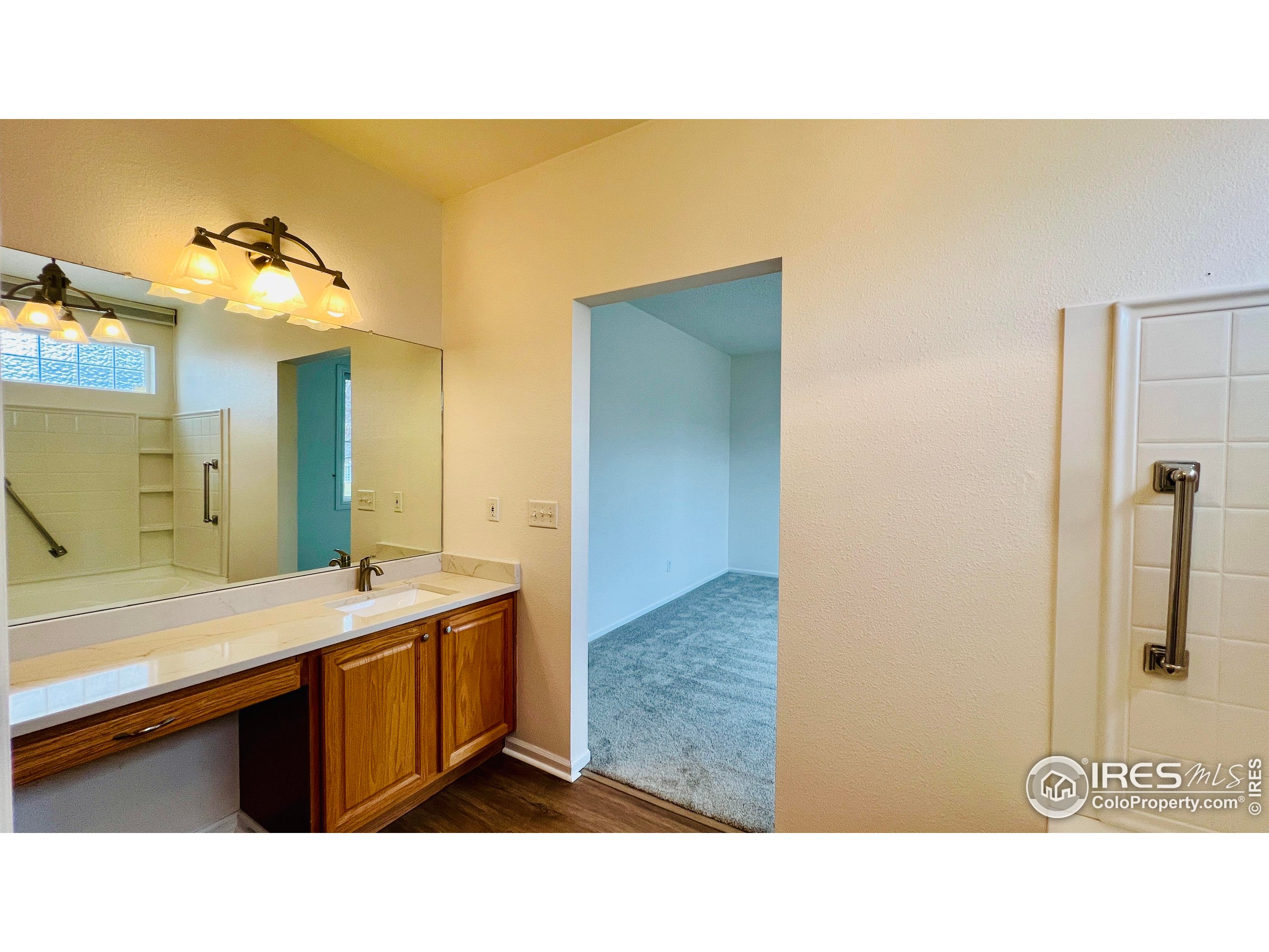 13963 Cook Street Thornton, CO 80602 - Photo 13 of 18 a bathroom with a sink double vanity and a mirror