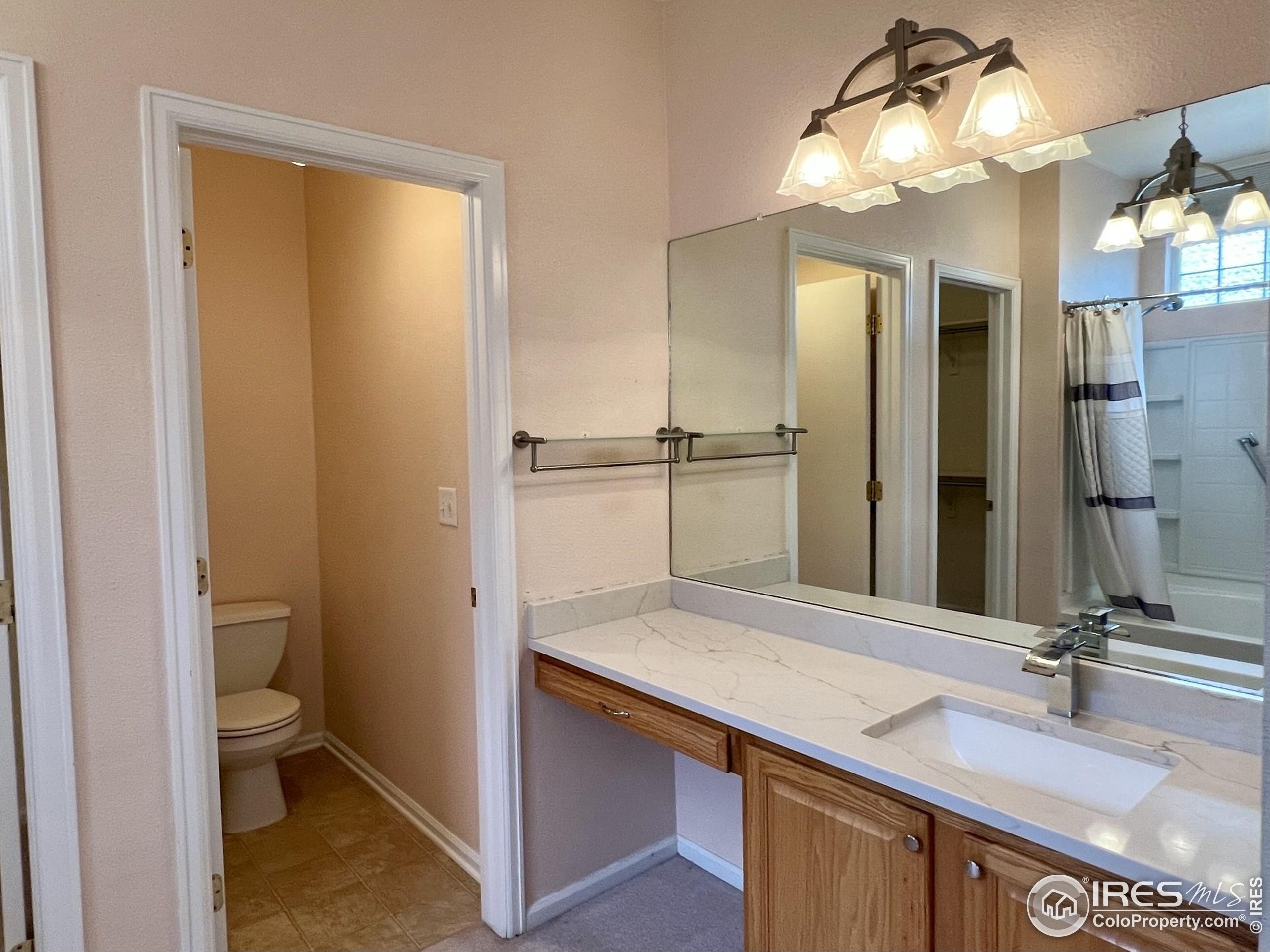 13963 Cook Street Thornton, CO 80602 - Photo 15 of 18 a bathroom with a sink and a mirror
