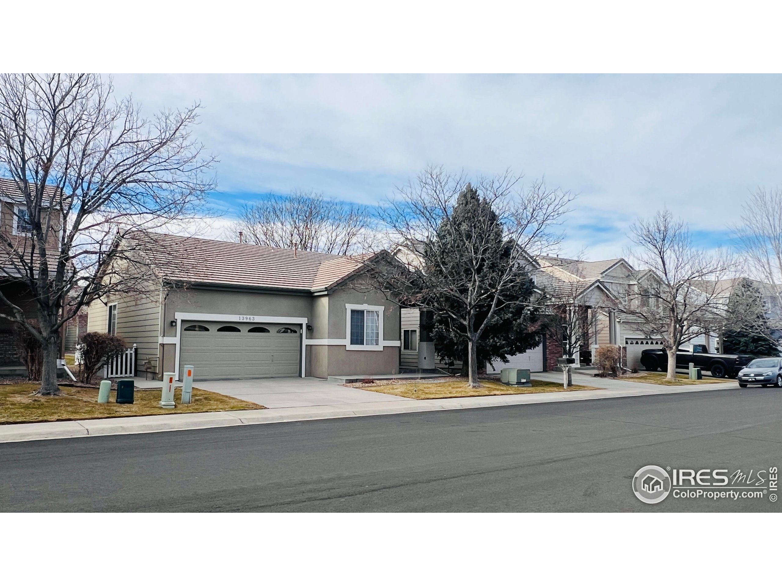 13963 Cook Street Thornton, CO 80602 - Photo 2 of 18 a view of road with large trees