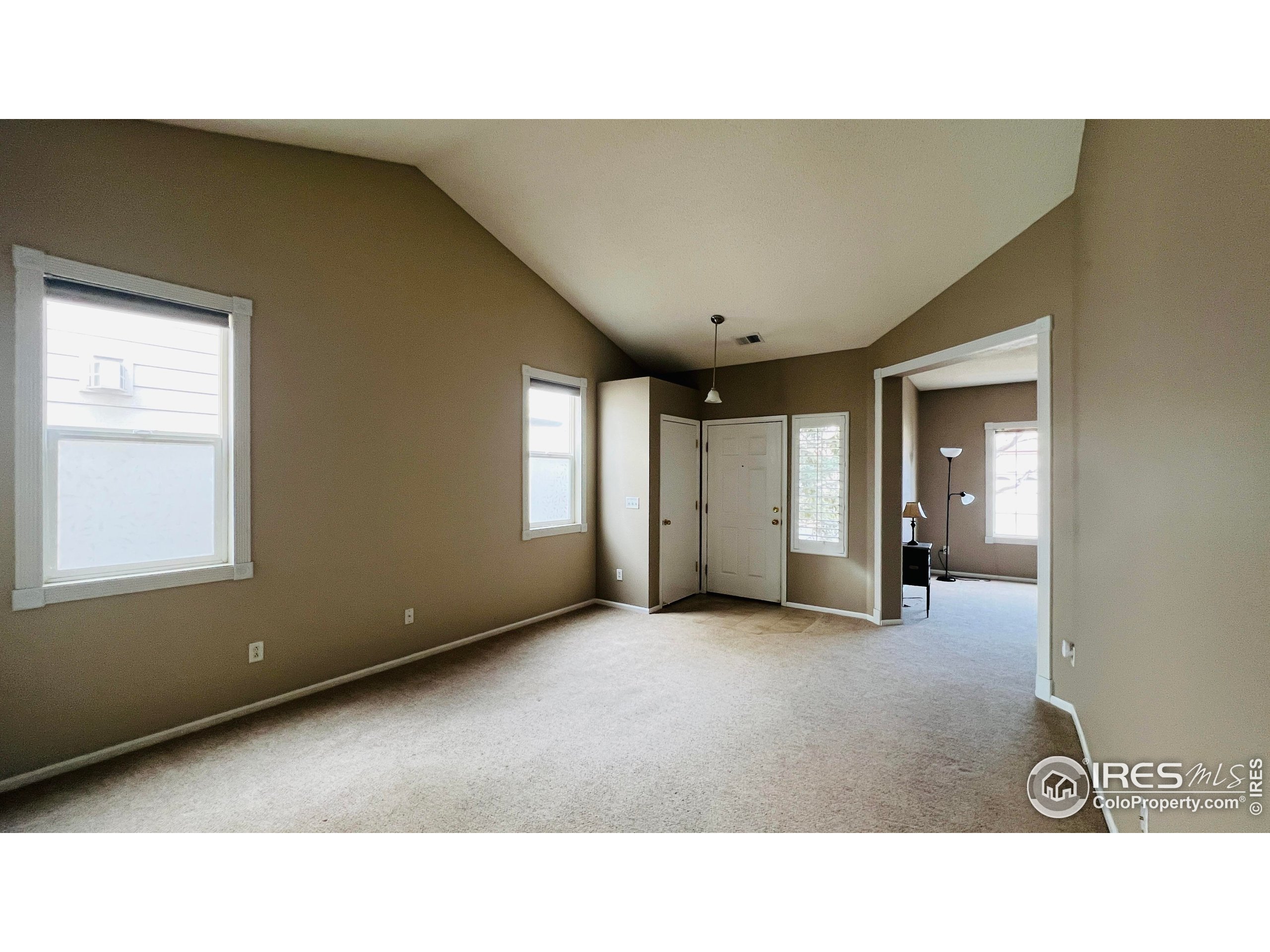 13963 Cook Street Thornton, CO 80602 - Photo 4 of 18 a open hall with a cabinet and stairs
