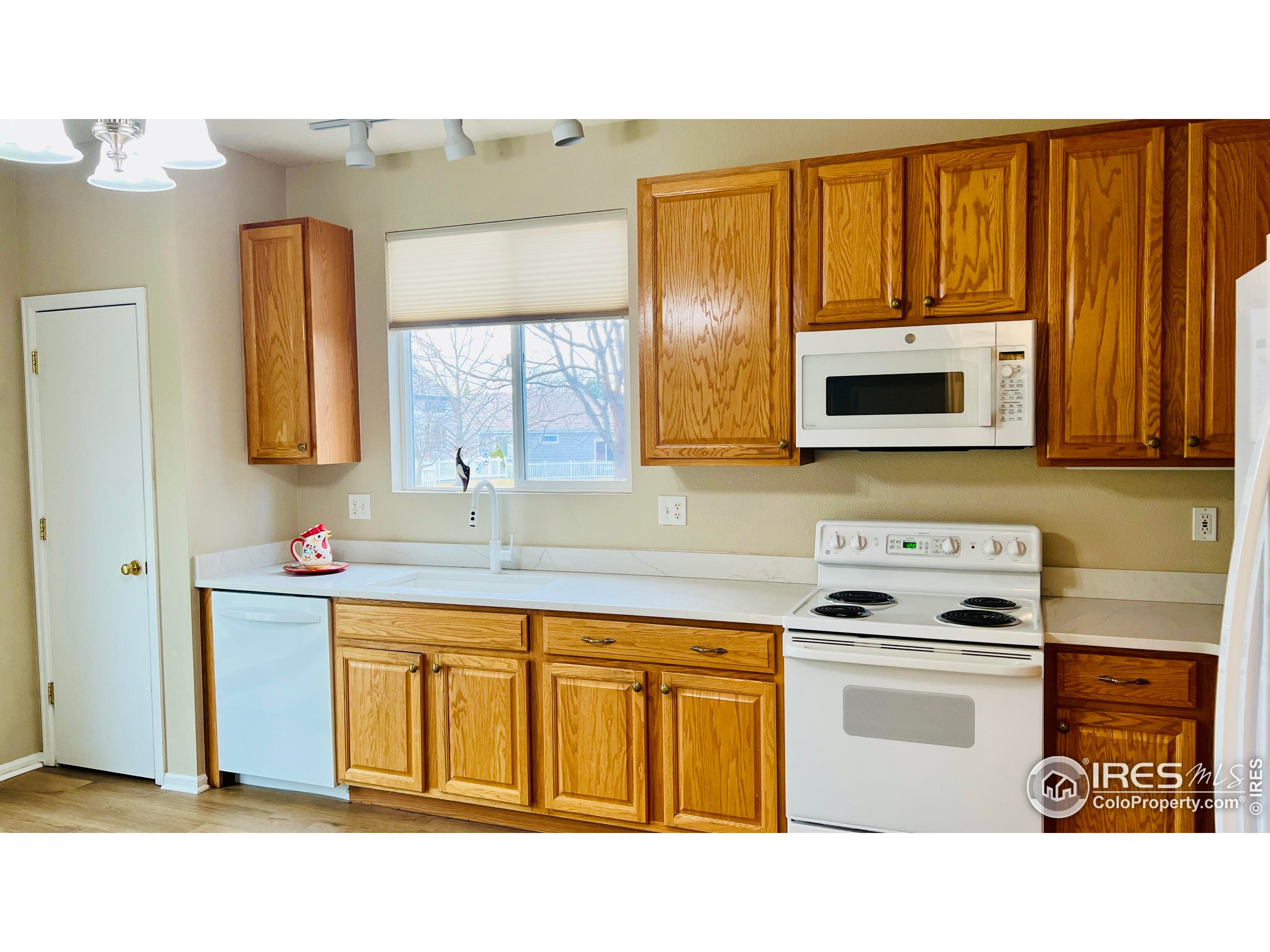 13963 Cook Street Thornton, CO 80602 - Photo 7 of 18 a kitchen with stainless steel appliances a stove microwave and sink