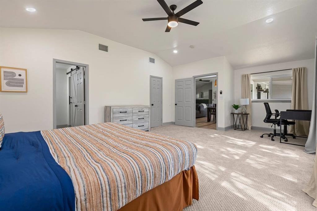 4918 Farris Road Denton, TX 76208 - Photo 14 of 28 a bedroom with a bed and a chandelier