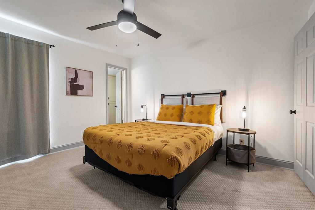 4918 Farris Road Denton, TX 76208 - Photo 15 of 28 a bed sitting in a bedroom next to a window and a chandelier