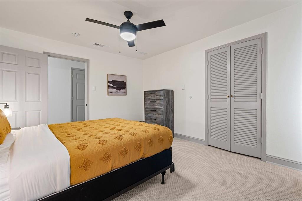 4918 Farris Road Denton, TX 76208 - Photo 16 of 28 a bedroom with a bed and a chandelier