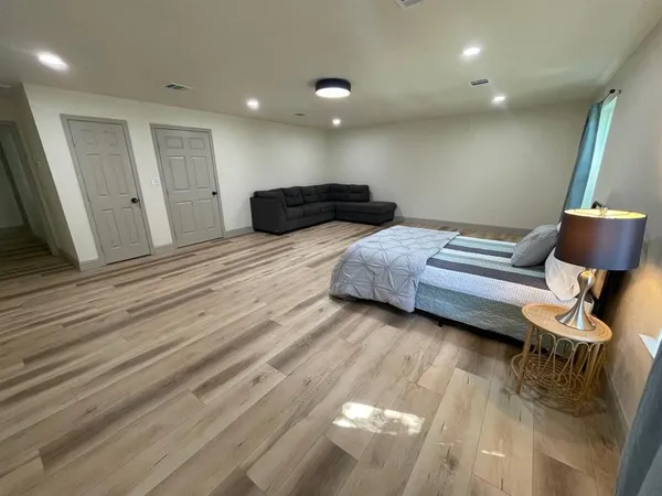 a bedroom with bed and chair