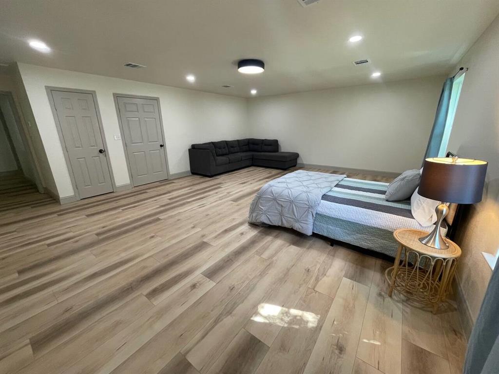 4918 Farris Road Denton, TX 76208 - Photo 20 of 28 a bedroom with bed and chair