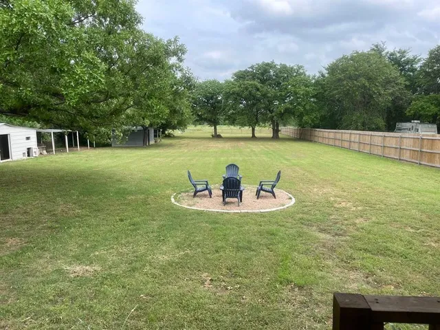 a view of a swimming pool with a yard
