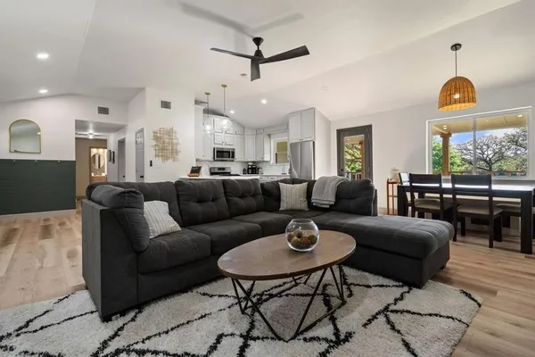 a living room with furniture a rug and a chandelier