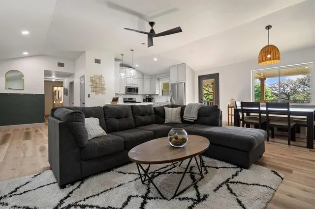 a living room with furniture a rug and a chandelier