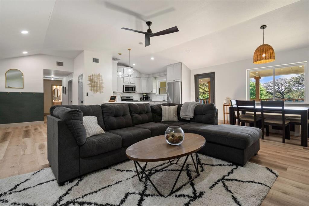 4918 Farris Road Denton, TX 76208 - Photo 4 of 28 a living room with furniture a rug and a chandelier