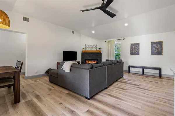 a living room with furniture and a wooden floor