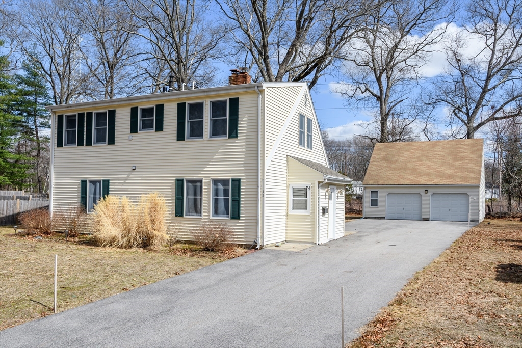 a view of a house with a yard covered in snow