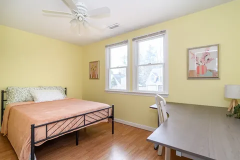 a bedroom with a bed and a table in it
