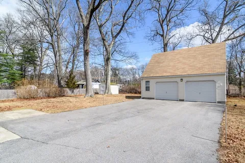 a view of large house with a yard and garage