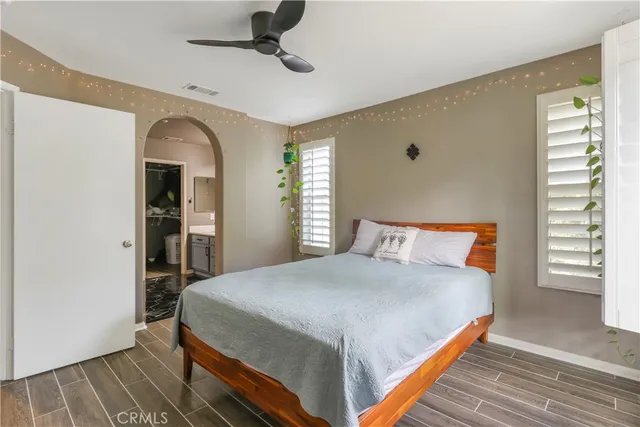 a bedroom with a large bed and a chandelier