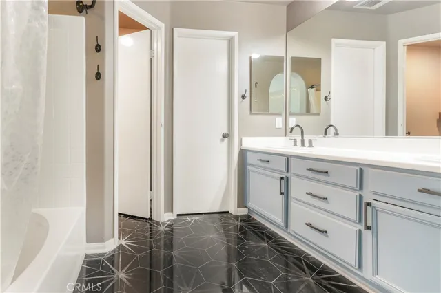 a bathroom with a double vanity sink mirror and