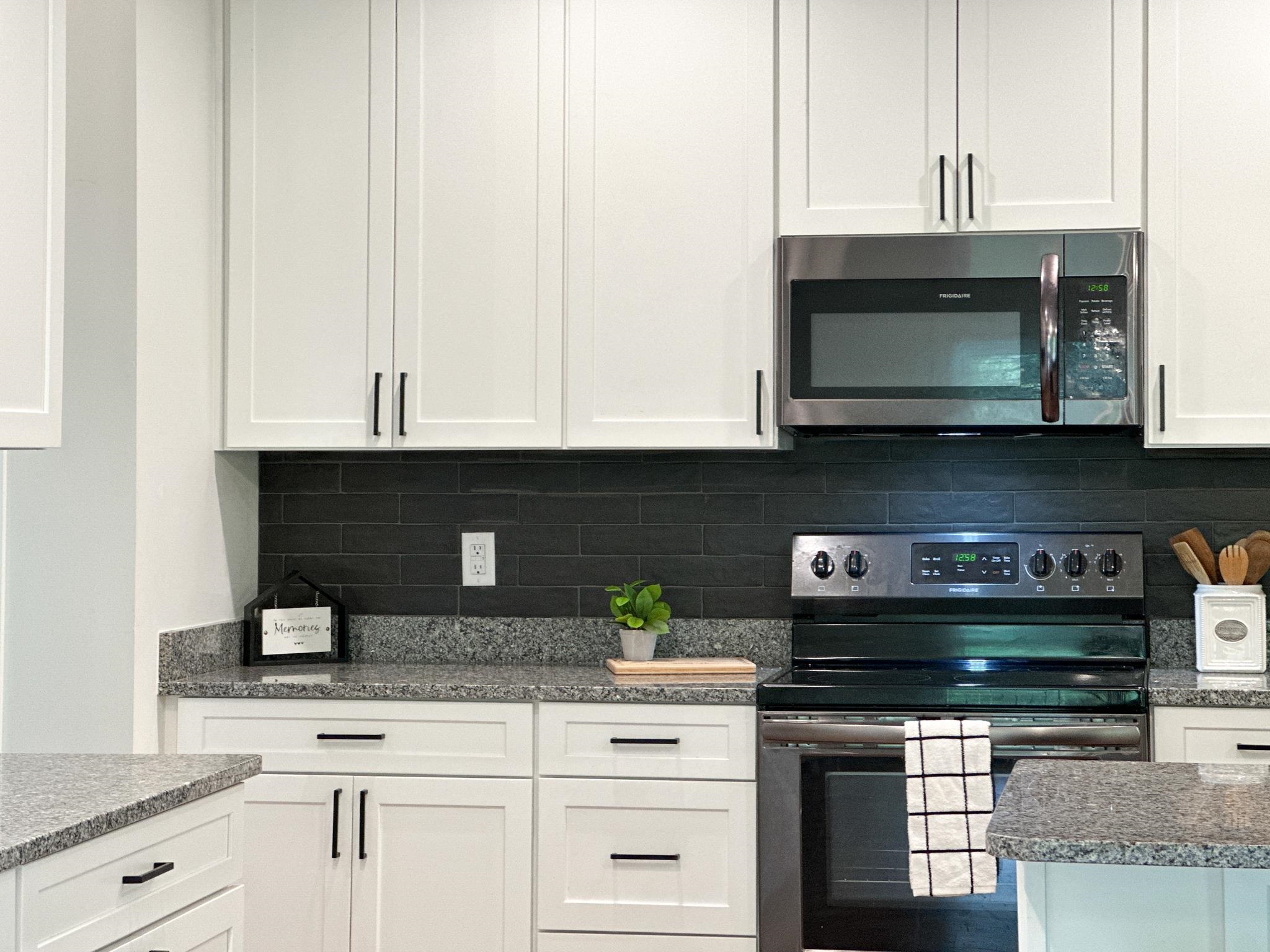 55 Mcilwee Lane Staunton, VA 24401 - Photo 18 of 40 a kitchen with stainless steel appliances granite countertop white cabinets and a stove a oven with white countertops