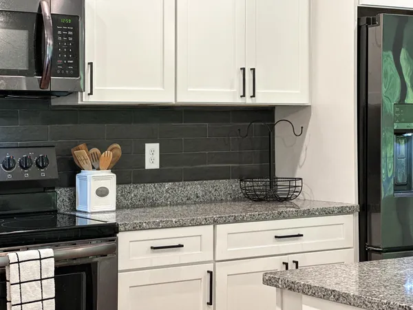 a kitchen with granite countertop cabinets and window