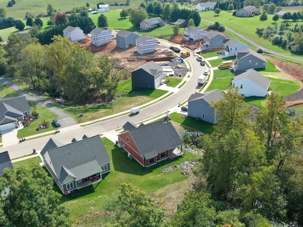 an aerial view of a house with a garden and swimming pool