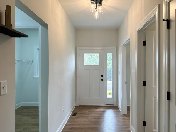 a view of a hallway with wooden floor