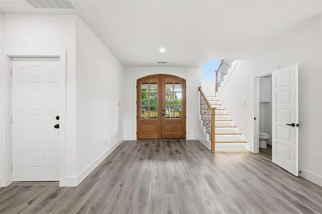 a view of a bedroom with furniture window and wooden floor