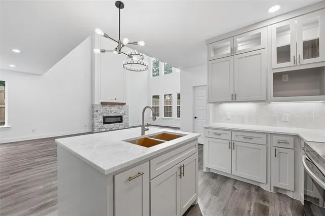 a kitchen with kitchen island a sink stainless steel appliances and refrigerator