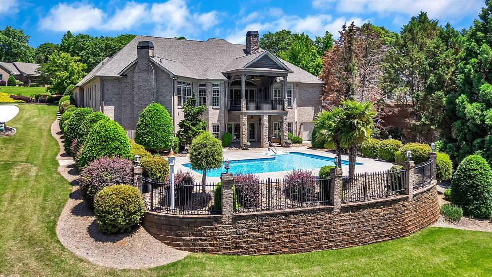 114 Willowbend Drive Anderson, SC 29621 - Photo 2 of 50 This spacious brick estate boasts a private pool and a beautiful, tiered retaining wall.