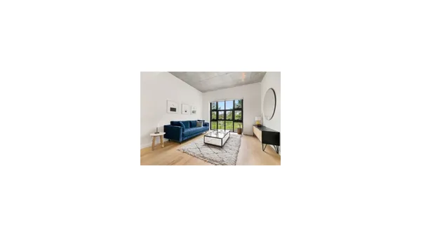 a bedroom with a white bed and a white cabinet