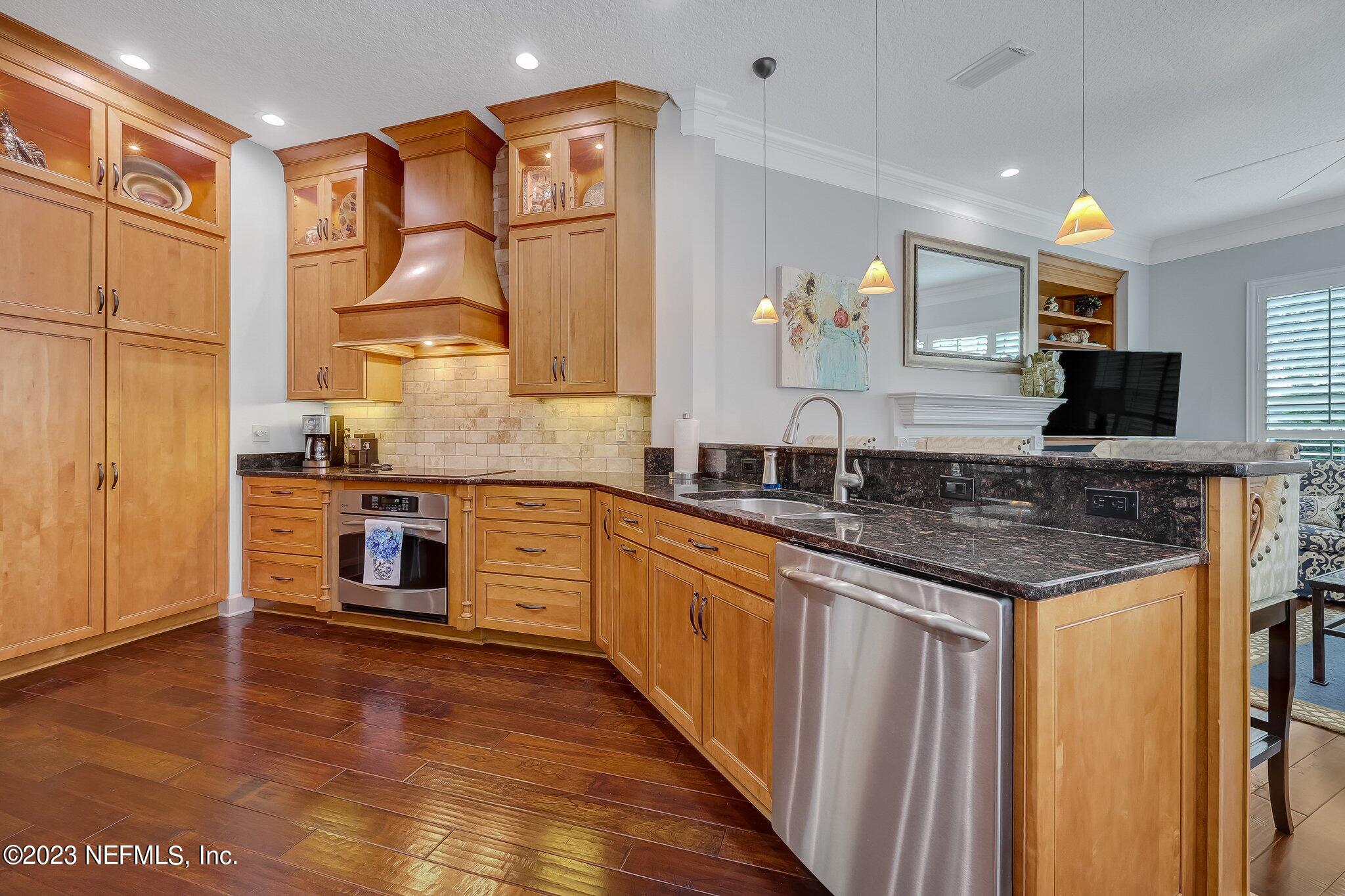 8026 Pine Lake Road Jacksonville, FL 32256 - Photo 12 of 43 a kitchen with stainless steel appliances granite countertop a sink and wooden cabinets