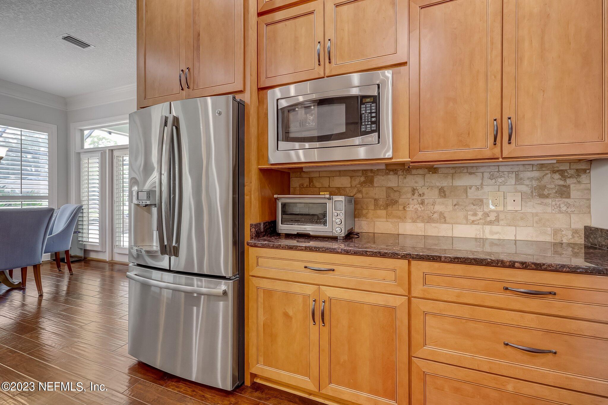 8026 Pine Lake Road Jacksonville, FL 32256 - Photo 13 of 43 a kitchen with appliances cabinets and a counter top space